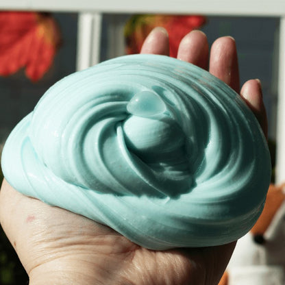 Teal colored Thicc Boi base and a 2oz gold clear slime topper.