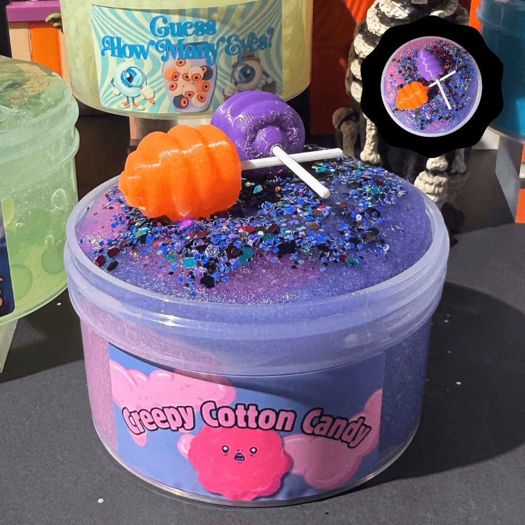 Dual-toned purple Creepy Cotton Candy icee slime topped with fine glitter, an orange pumpkin, and a purple lollipop charm.