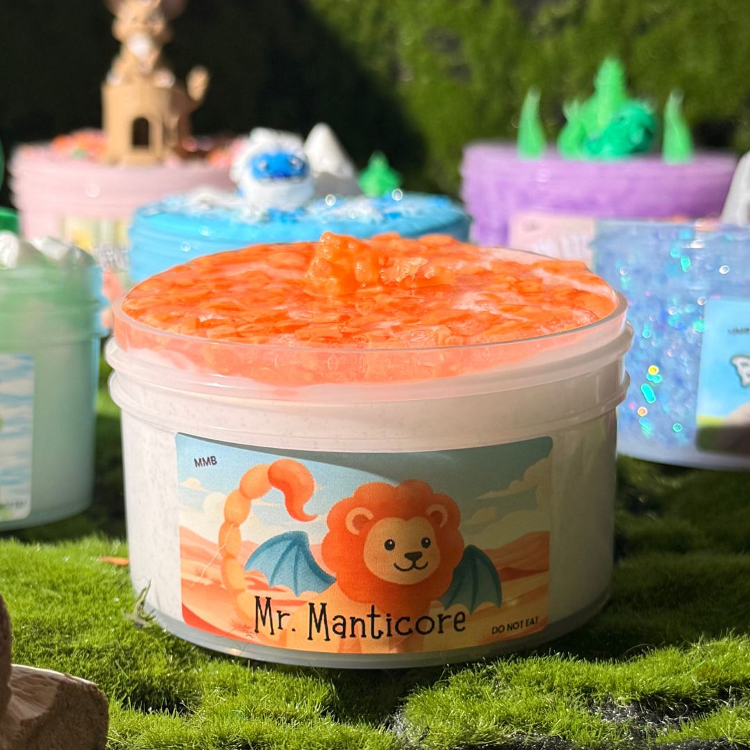 Jar of Mr. Manticore sand slime topped with orange translucent silica rocks, featuring a lion-manticore label.