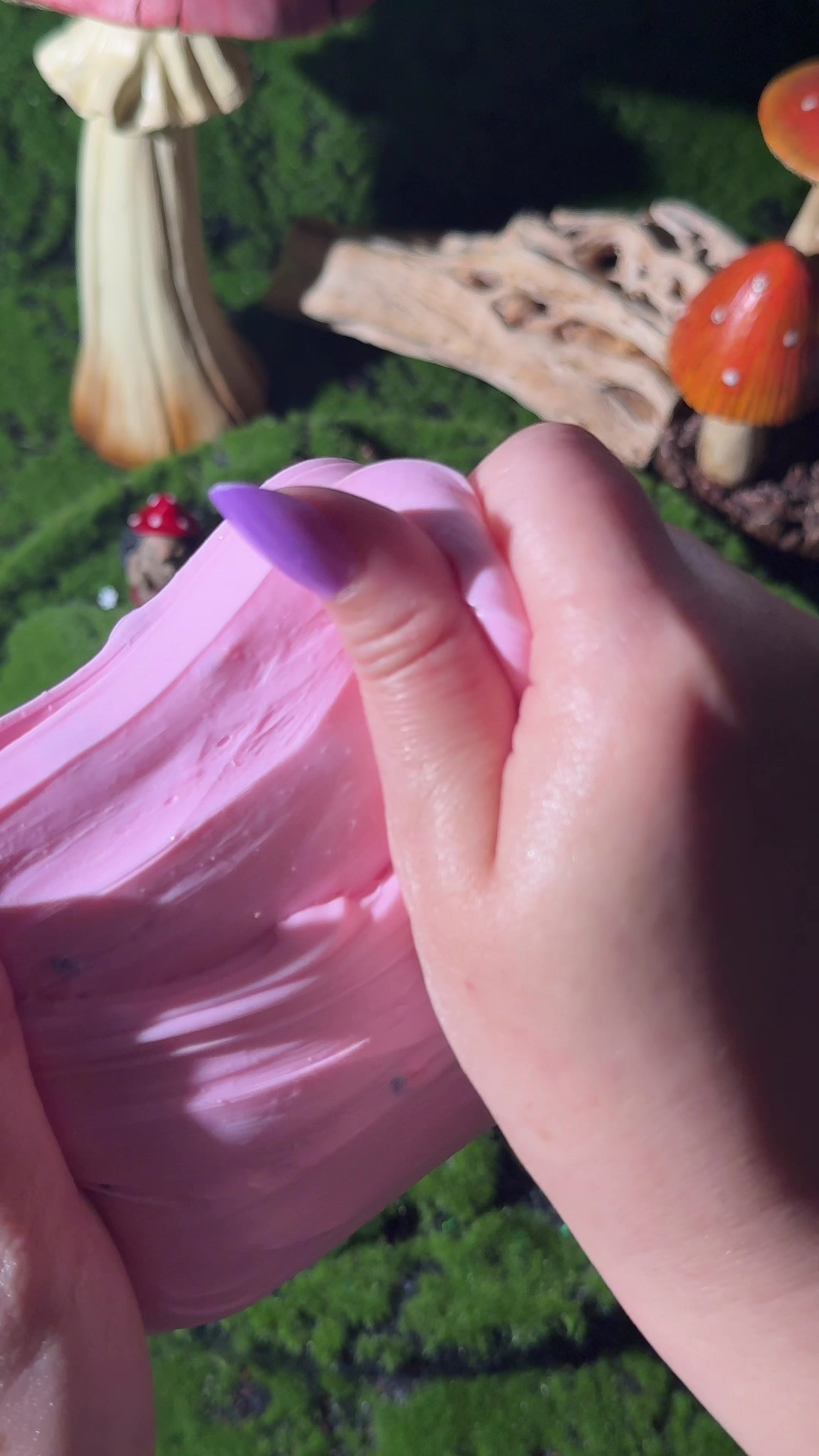 Pink Jackalope slime tub with a 3D-printed jackalope and stump charm on top, set outdoors on green moss.